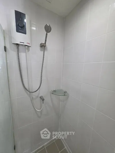 Modern bathroom with sleek shower unit and white tiled walls