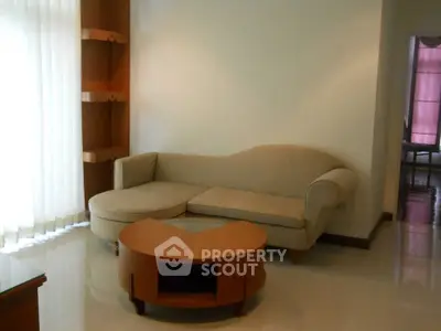 Cozy living room with elegant beige sofa and stylish wooden coffee table