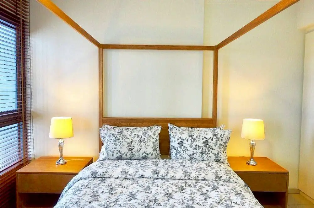 Elegant bedroom with wooden bed frame and stylish lamps