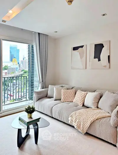 Modern living room with cozy sofa and city view balcony in high-rise apartment.