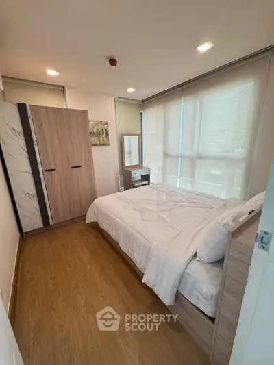 Modern bedroom with wooden flooring and stylish wardrobe in a cozy apartment.