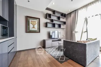 Modern living room with sleek furniture and large windows offering natural light.