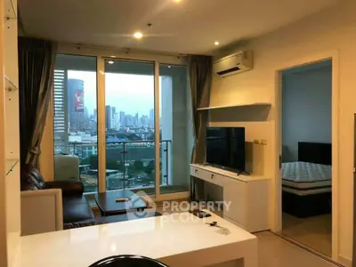 Modern living room with city view, open layout, and stylish furnishings in a high-rise apartment.