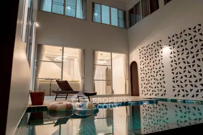 Luxurious indoor pool area with modern design and stylish lounge chair, perfect for relaxation and entertainment.