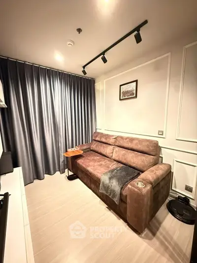 Cozy living room with plush sofa and elegant decor, perfect for relaxation.