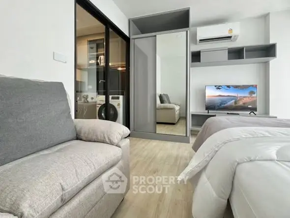 Modern bedroom with cozy seating and sleek storage solutions