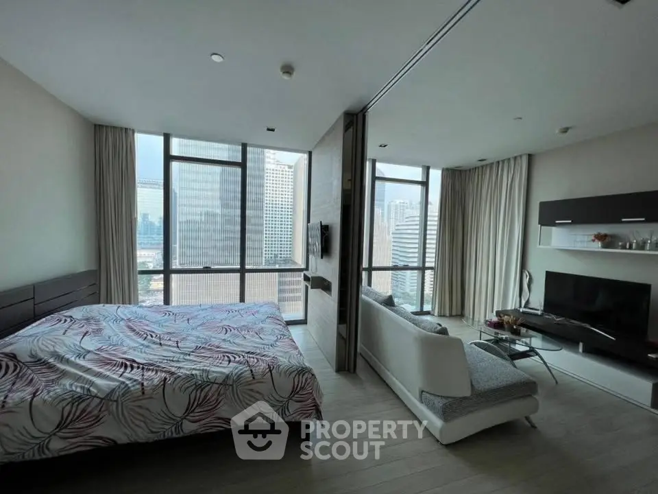 Modern studio apartment with city view, featuring a cozy living area and stylish bedroom.