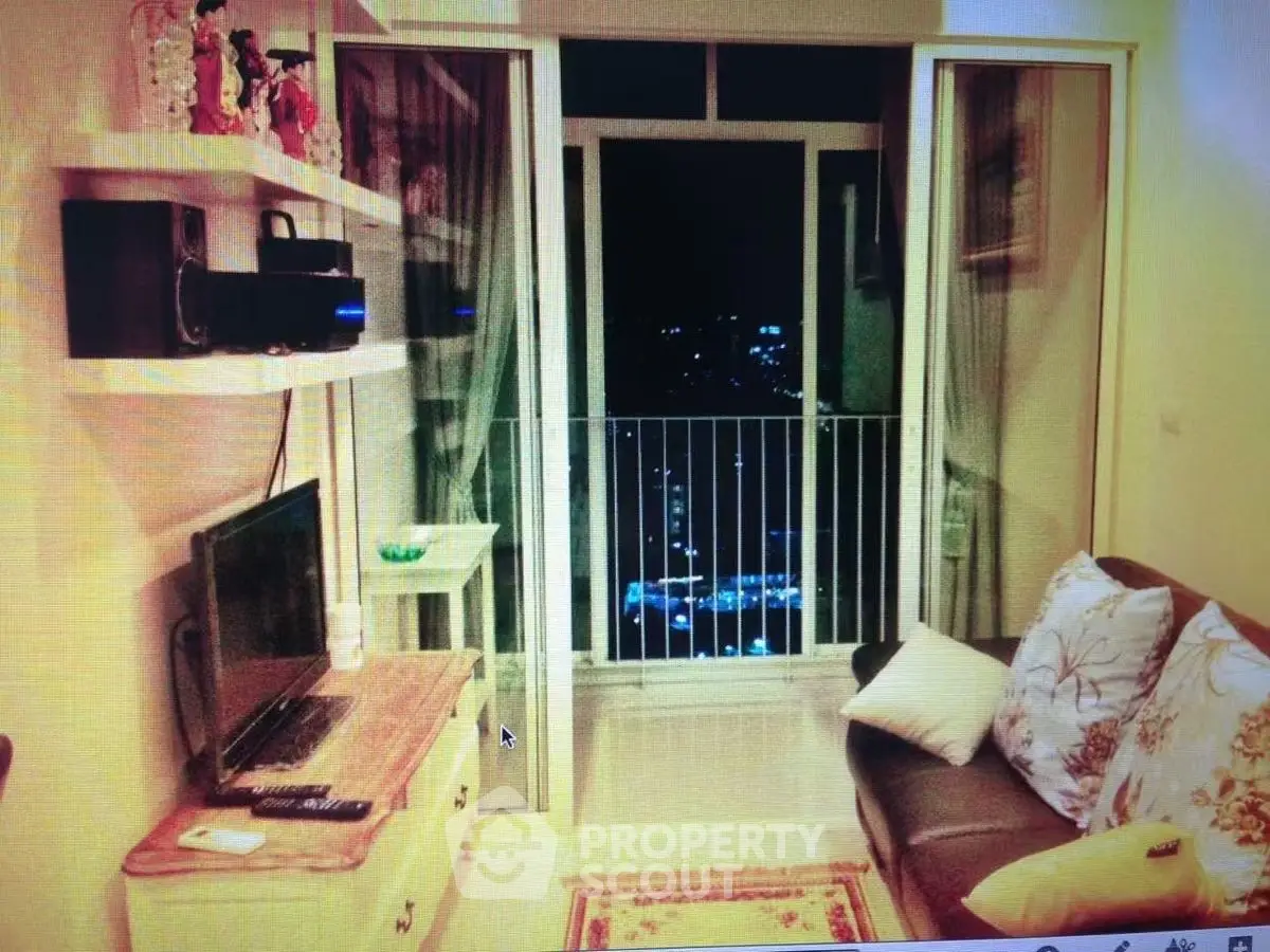 Cozy living room with balcony view, featuring modern decor and comfortable seating.