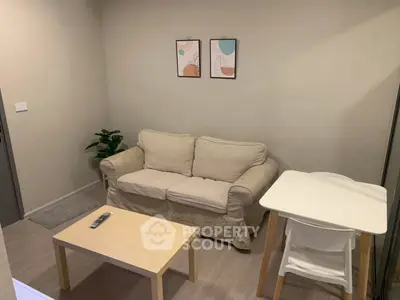 Cozy living room with beige sofa, modern decor, and wooden furniture