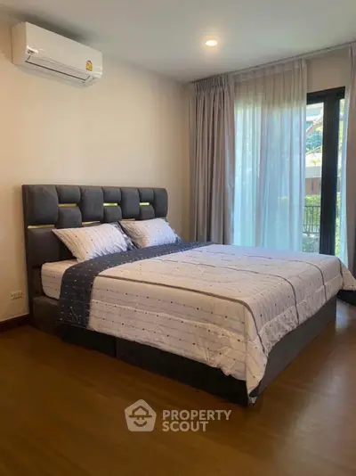 Modern bedroom with stylish bed and natural light from large window