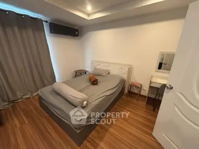 Cozy bedroom with modern design and wooden flooring
