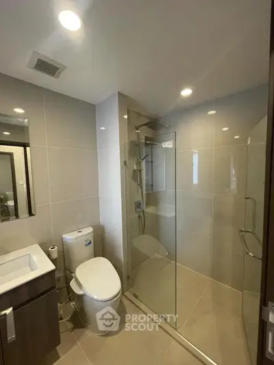Modern bathroom with glass shower and sleek fixtures