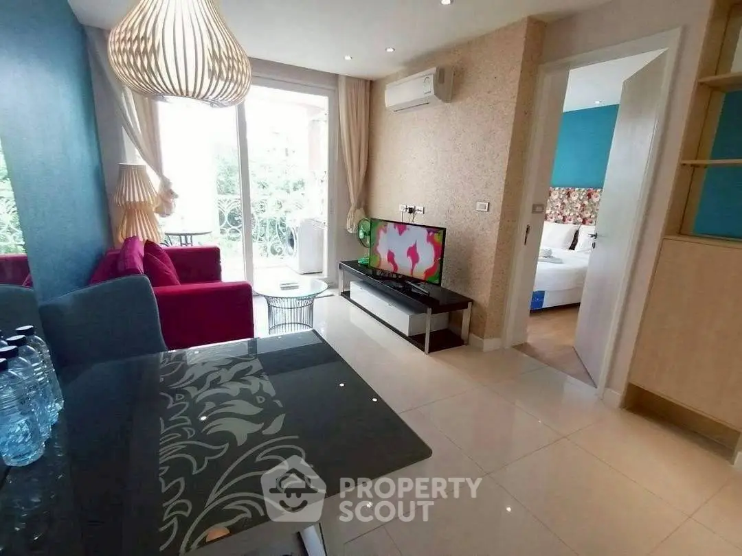 Modern living room with stylish decor and open view to bedroom