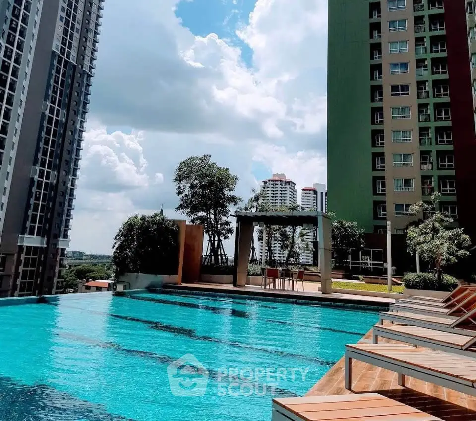 Luxurious high-rise apartment with stunning pool and city views, perfect for urban living.