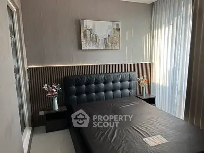 Modern bedroom with stylish decor and large window for natural light