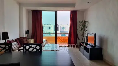 Spacious living room with modern decor and balcony view, perfect for relaxation and entertainment.