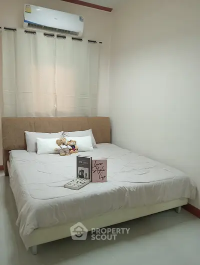 Cozy bedroom with plush bed and stylish decor, perfect for relaxation.