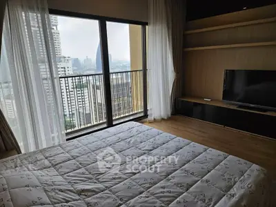 Modern bedroom with city view and large windows in high-rise apartment