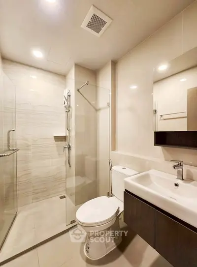 Modern bathroom with glass shower and sleek fixtures