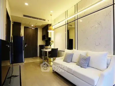 Modern living room with elegant decor and cozy seating in a stylish apartment.