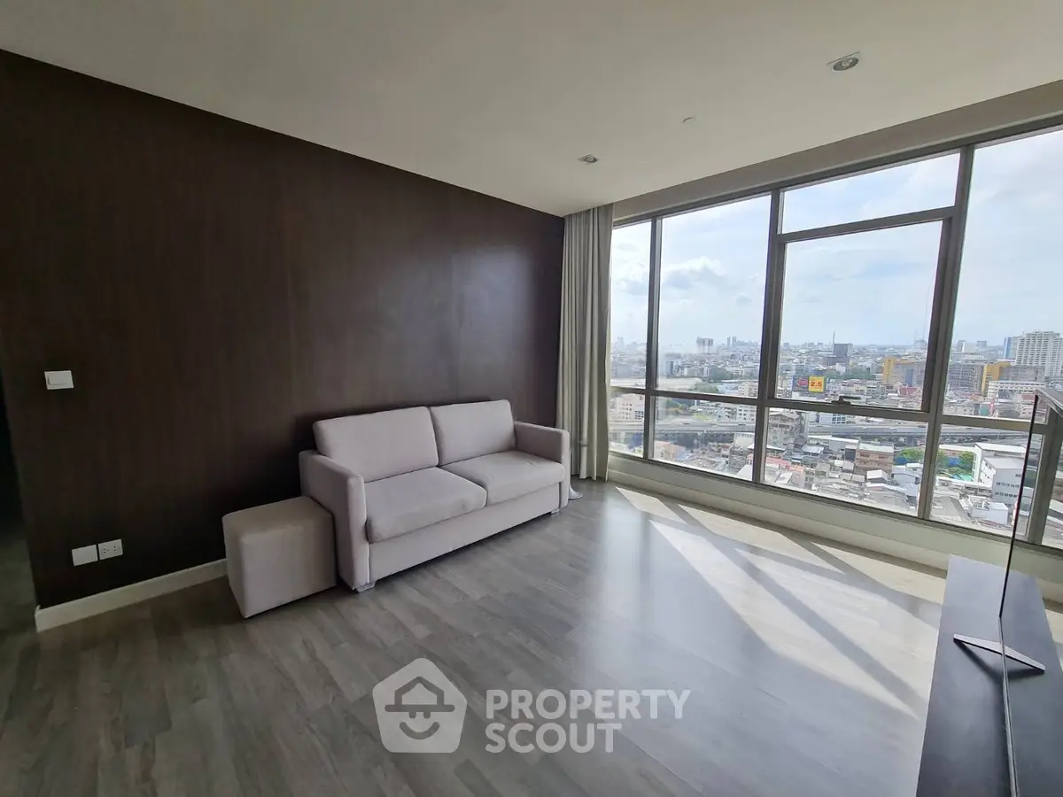 Spacious living room with panoramic city view and modern decor
