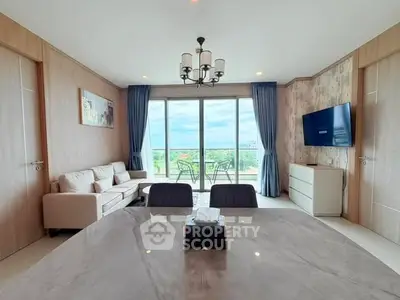 Spacious living room with modern decor and large windows offering scenic views.