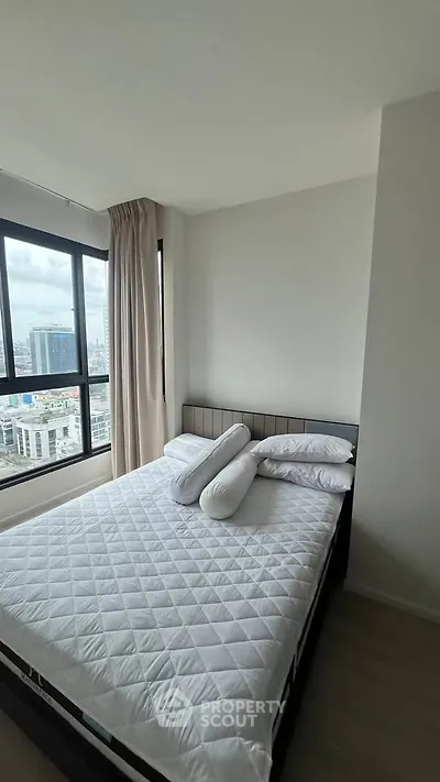 Modern bedroom with city view and cozy bed in high-rise apartment