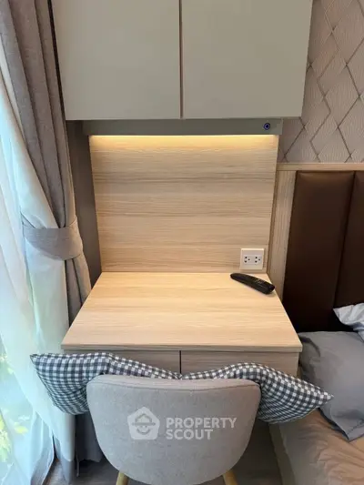 Cozy study nook with modern desk and chair by a window, perfect for productivity and relaxation.