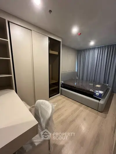 Modern bedroom with sleek wardrobe and cozy bed in stylish apartment.