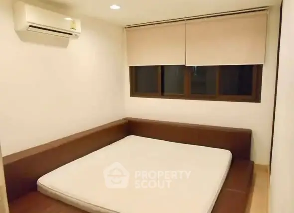 Cozy minimalist bedroom with built-in bed and air conditioning