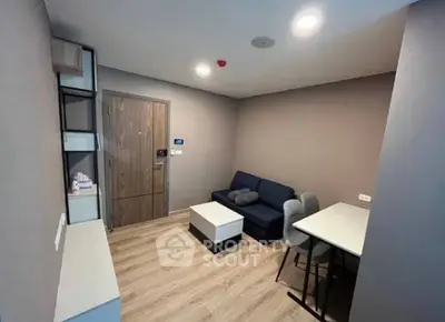 Modern living room with sleek furniture and wooden flooring in a cozy apartment.