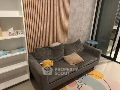 Cozy living room with plush gray sofa and modern decor, perfect for relaxation.