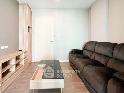 Modern living room with sleek black sofa and stylish wooden furniture