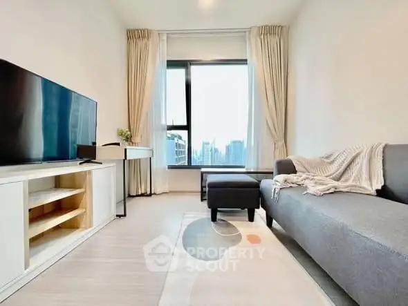 Modern living room with large window and city view, featuring sleek furniture and stylish decor.