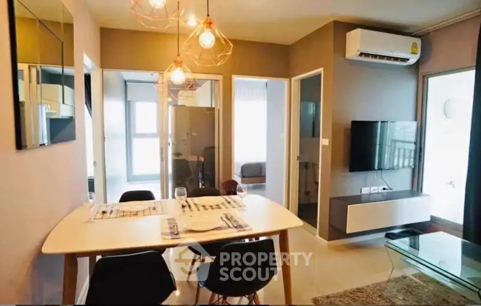 Modern dining area with stylish lighting and open layout in a contemporary apartment.