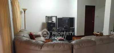 Spacious living room with cozy sectional sofa and entertainment center