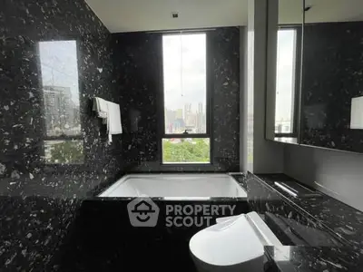 Luxurious bathroom with city view and elegant black marble finish