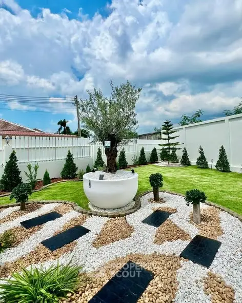 Stunning landscaped garden with modern design and lush greenery under a vibrant sky.