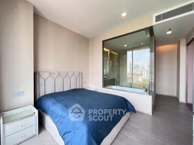 Luxurious bedroom with city view and modern ensuite bathtub