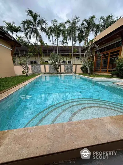 Luxurious private pool surrounded by lush greenery and modern architecture