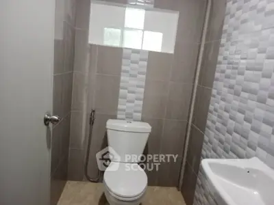 Modern bathroom with sleek tiles and compact design