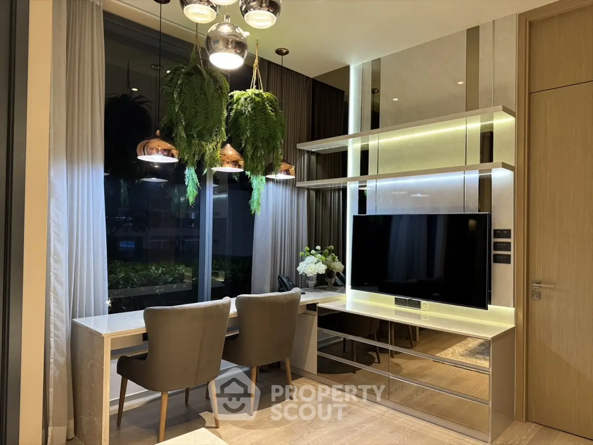 Luxurious modern living room with elegant decor and large TV unit, perfect for relaxation and entertainment.