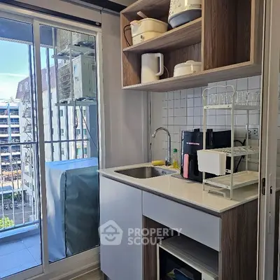 Modern kitchen with balcony view and sleek cabinetry