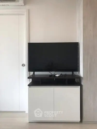 Modern living room with sleek TV stand and flat-screen television.
