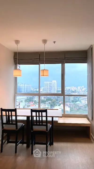 Spacious high-rise apartment dining area with large windows offering a panoramic city view, modern lighting, and elegant wooden furniture.