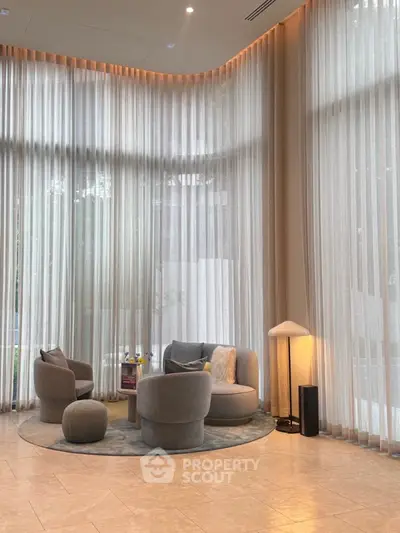 Luxurious modern living room with floor-to-ceiling windows and elegant furniture