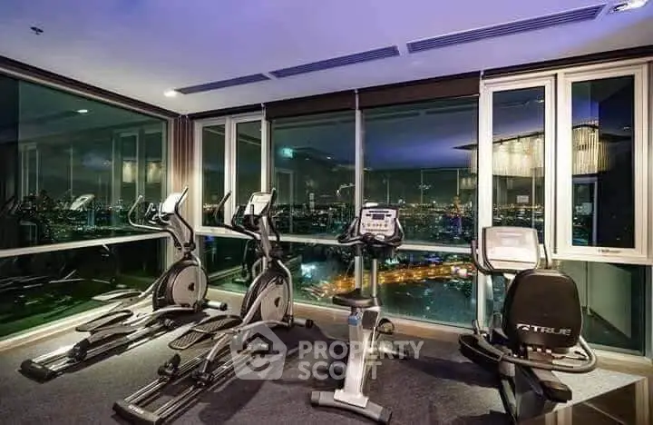 Luxurious high-rise gym with panoramic city views and modern fitness equipment.