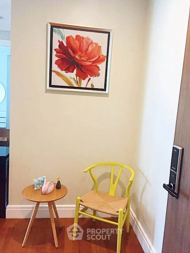 Charming corner with vibrant art and modern chair in cozy interior space.