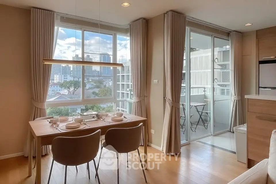Modern dining area with city view and balcony access in a stylish apartment