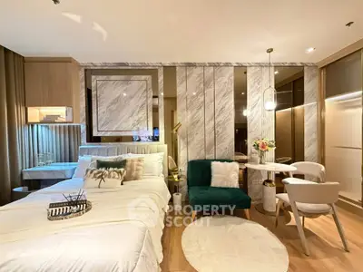 Luxurious modern bedroom with elegant decor and cozy seating area in a stylish apartment.